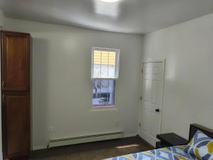 an empty bedroom with a window and a bed at Hotel motel in Linden