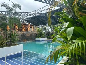 a swimming pool in a resort with plants at Vegas Resort and Hotel in Balayong