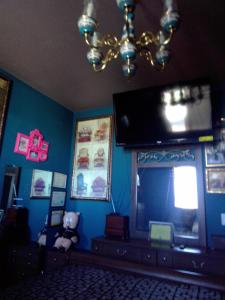 a living room with a tv and a teddy bear at Big YELLOW HOUSE On The Hill in Reno +5 photos