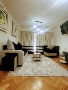 a living room with a couch and a table at Apartment Mukarram in Santiago
