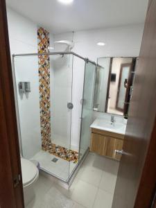 ein Badezimmer mit Dusche, Toilette und Waschbecken in der Unterkunft Encantador Apartamento El Laguito Bocagrande in Cartagena de Indias