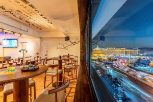 a restaurant with tables and a view of a city at Xi'an YOLO Guest House in Xi'an