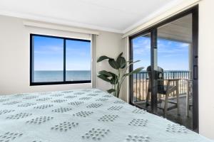 a bedroom with a bed and a view of the ocean at Bright Oceanfront 2BR Condo Balcony, King Bed & Parking in Ocean City +31 photos