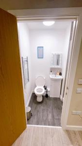 a bathroom with a white toilet and a sink at City Views Top Floor - Bradford City Center in Bradford