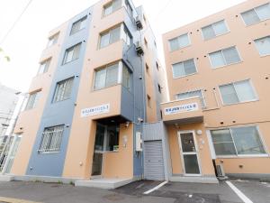 a building on the corner of a street at Tabist JKNツインホテル in Asahikawa +64 photos