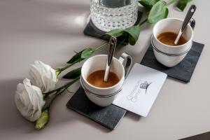 two cups of coffee on a table with a napkin at Colosseum Corner in Rome