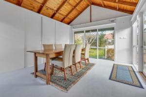 a dining room with a wooden table and chairs at Cottswold in Paynesville