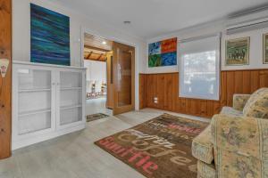 a living room with a couch and a rug at Cottswold in Paynesville