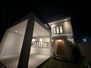 a house with a door in the night at Casa Luma Canggu in Canggu