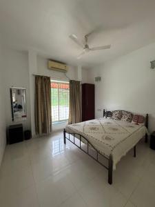 a bedroom with a bed and a ceiling fan at Lotus in Lonavala