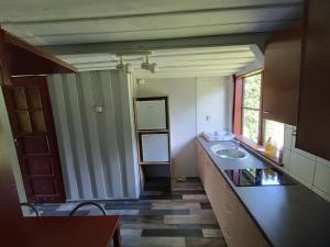 a bathroom with a sink and a counter top at Domek nad Trojanką koło Olsztyna Blisko jeziora in Wrzesina +10 photos