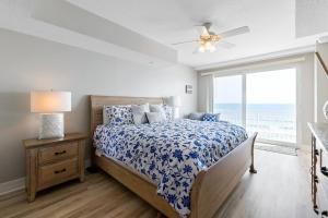 a bedroom with a bed and a large window at Beachfront 3br Condo With Stunning Views Daytona in Daytona Beach Shores +52 photos