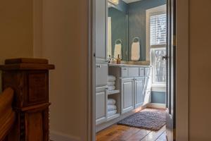 a bathroom with a sink and a mirror at The Maple House Fully Fenced-in Yard! in Saugatuck +21 photos