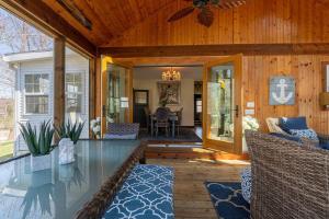 a porch of a house with a glass table and chairs at The Maple House Fully Fenced-in Yard! in Saugatuck