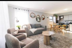 a living room with a couch and a table at Mortimer in Germiston