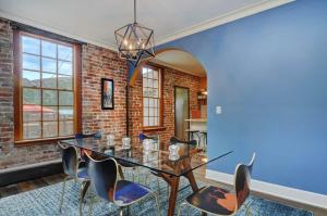 a dining room with a brick wall and a glass table and chairs at Salida Terrace House Str#447 in Salida
