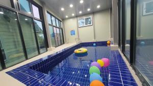 a room with a pool with balls on the floor at Daebudo Nurimaru Pension in Ansan