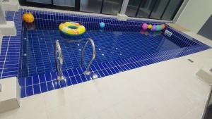a toy swimming pool with tennis rackets and balls at Daebudo Nurimaru Pension in Ansan