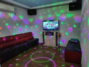 a living room with a couch and a flat screen tv at Daebudo Nurimaru Pension in Ansan +27 photos