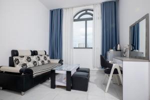 a living room with a couch and a table at White Diamond Hotel in Ho Chi Minh City