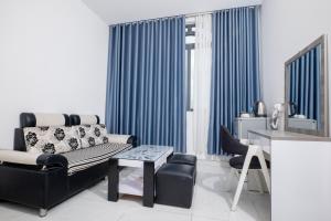 a living room with a couch and a table at White Diamond Hotel in Ho Chi Minh City +60 photos