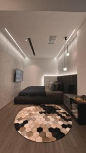 a living room with a bed and a rug at Here Hotel 宅這兒私宅-屏市A宅 in Pingtung City
