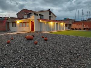 a house with orange balls on the ground in front of it at Sierra Alta House in Espinar
