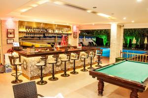a pool table in a room with a bar and a pool table at Sunway Apart Hotel in Alanya