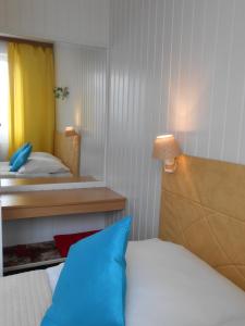 ein Schlafzimmer mit einem Bett mit einem blauen Kissen in der Unterkunft Hotel Leon in Biała Podlaska