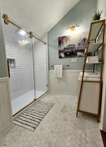 a bathroom with a walk in shower and a ladder at Historic Farmhouse - Tranquil Country Nature Escape in Hondo +29 photos