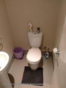 a bathroom with a white toilet and a sink at Palmyra Secure holidays Townhouse in Bicton +20 photos