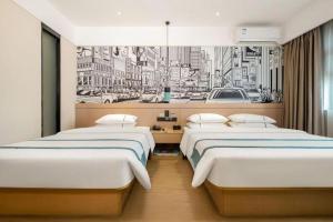 two beds in a hotel room with a drawing of a city at City Comfort Inn Nanning Taoyuan Road in Nanning +219 photos