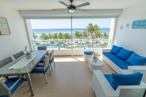 a dining room with a table and chairs and a view of the ocean at Marbella Juan Dolio Beachfront in Juan Dolio