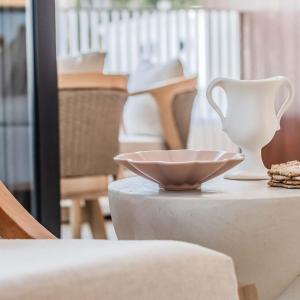 a white vase and a bowl on a table at Lakehouse No 2- Lakefront Luxury Escape Villa - Pet Friendly in Cabarita Beach
