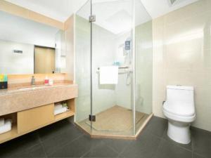 a bathroom with a toilet and a glass shower at City Comfort Inn Dali High-speed Railway Station Erhai Park in Dali +250 photos