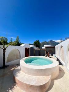 a hot tub in a circle on a patio at Batur Cozy Bali in Kintamani