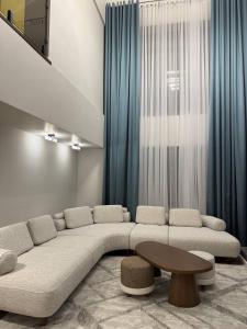 a living room with a large couch and a table at Villa Caprice 42 Issyk Kul in Bosteri
