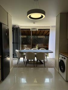 a dining room with a table and chairs at Villa Caprice 42 Issyk Kul in Bosteri +11 photos