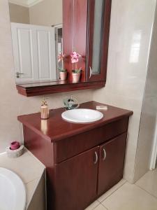 a bathroom with a sink and a mirror at Green Hills Farm House in Drummond +38 photos
