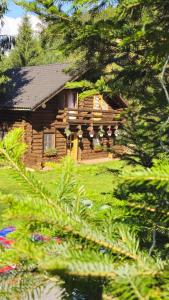 a log cabin in the middle of some trees at Cabana Daria Arieseni in Arieşeni