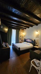 a bedroom with a large bed and a couch at Hotel Sarajet e Pashait 1 in Dhërmi +141 photos