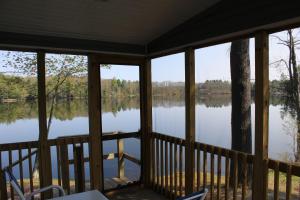 a view of a lake from a screened in porch at Alpine Lake Lakefront Park Model 4 in South Corinth