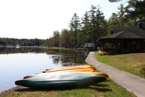 a row of boats sitting on the side of a lake at Alpine Lake Lakefront Park Model 4 in South Corinth