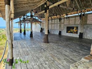 a large building with wooden floors and a painting on the wall at Dream Hill in Lovina