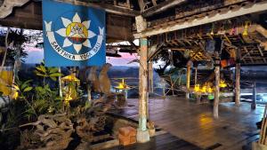 a flag hanging from a building with a wooden floor at Dream Hill in Lovina