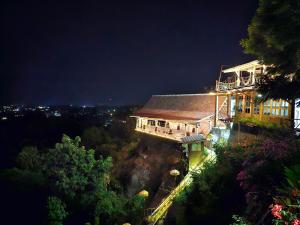 a large building at night with its lights on at Dream Hill in Lovina