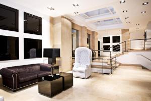 a living room with a couch and a chair at Hotel Clarin in Oviedo