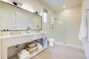 a bathroom with a sink and a mirror at Casa De La Vina - Boutique Apartments in Downtown Santa Barbara in Santa Barbara