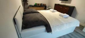 a bed with a black and white comforter at Sweet Home Inn in Świnoujście