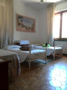 1 Schlafzimmer mit 2 Betten und einem Fenster in der Unterkunft Casa Ricciardi in Chianni